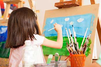 child painting in preschool