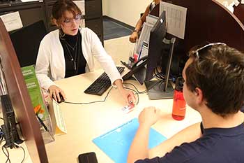 student getting help from financial aid services advisor
