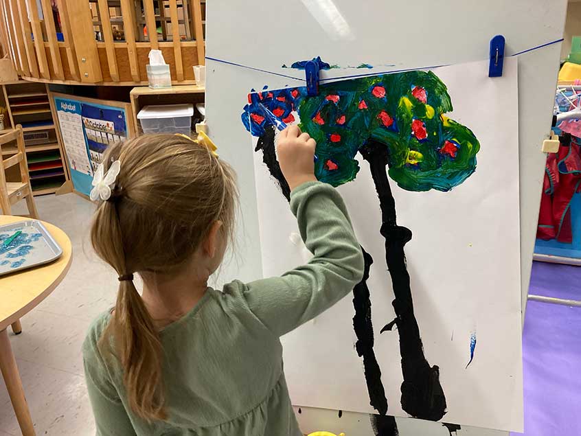 Nursery school child painting