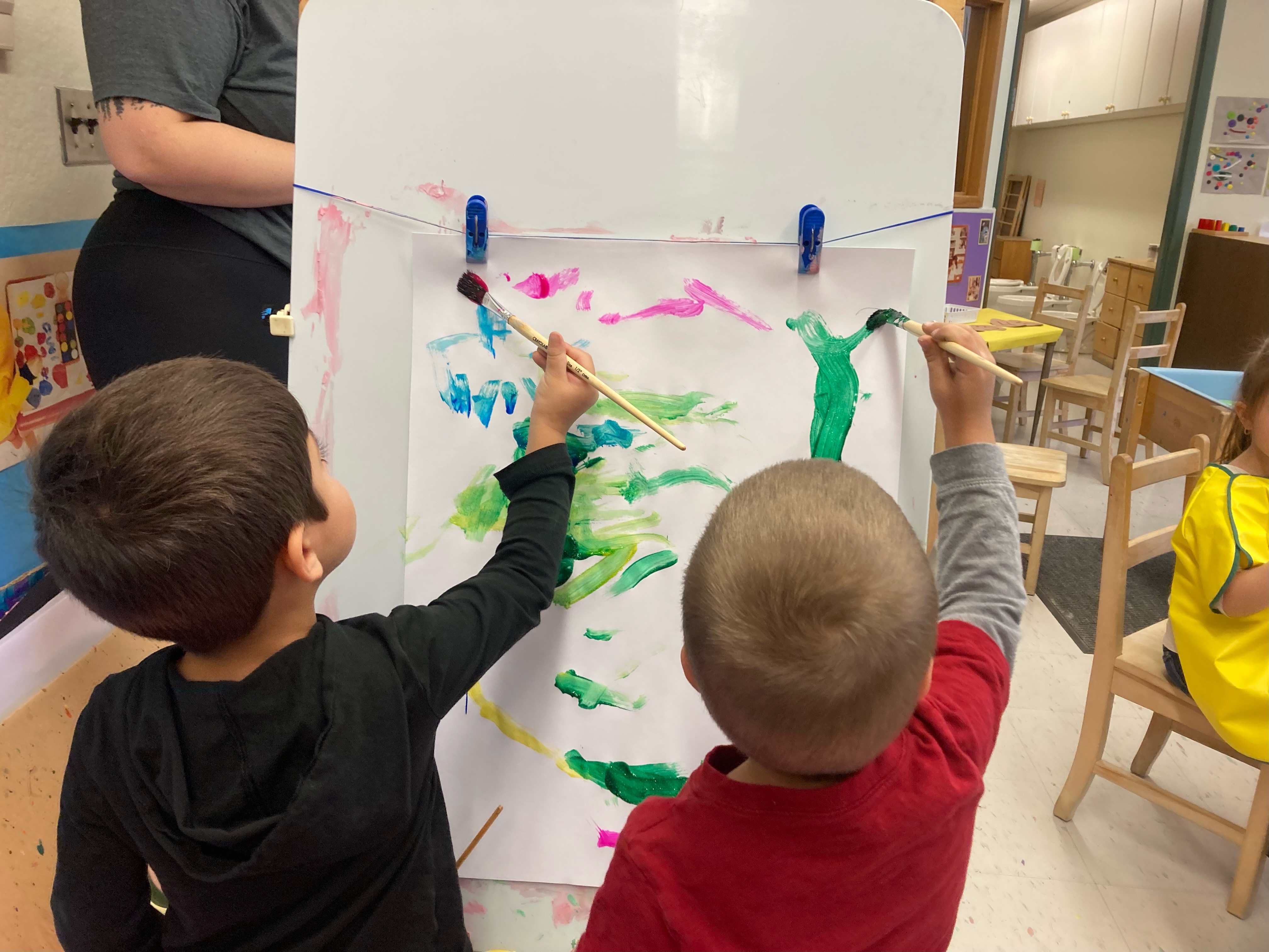 Nursery school children painting.