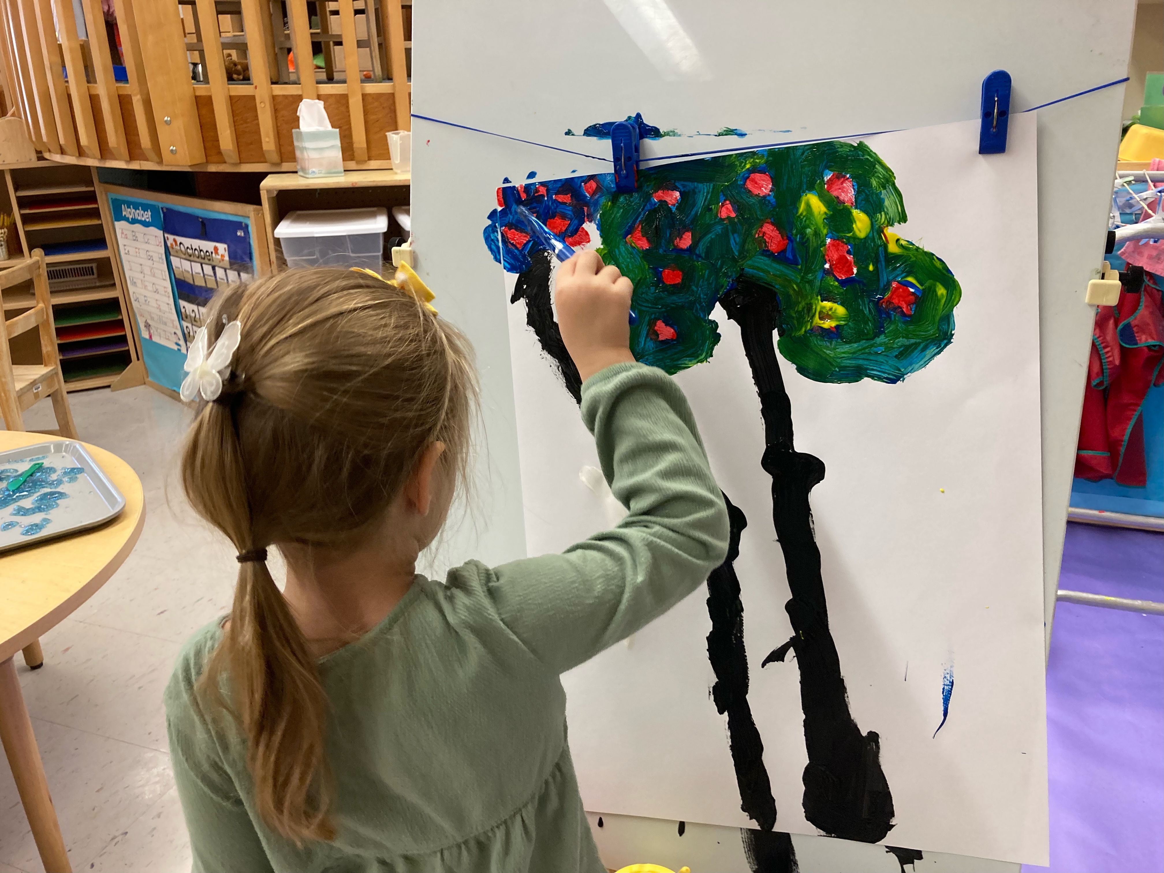 Nursery school child painting.